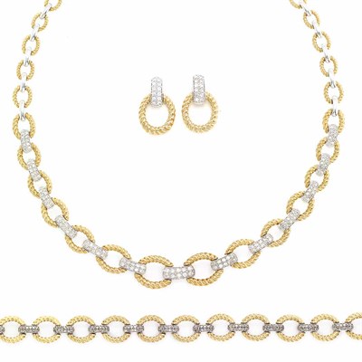Lot 702 - Two-Color Gold and Diamond Necklace, Bracelet and Pair of Earrings