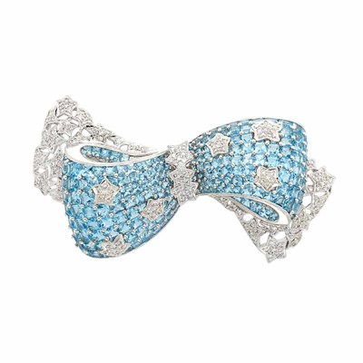 Lot 876 - White Gold, Blue Topaz and Diamond Bow Brooch