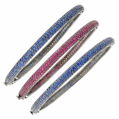 Lot 132 - Three Blackened Gold, Sapphire and Ruby Bangle Bracelets