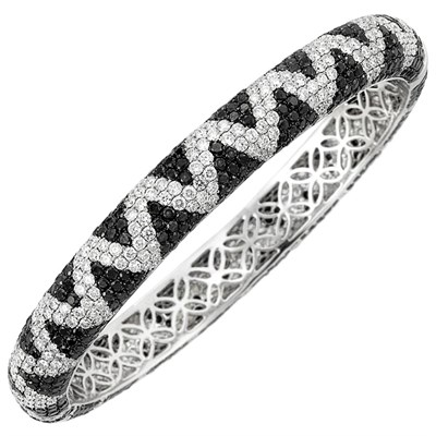 Lot 99 - White Gold, Diamond and Black Diamond Bangle Bracelet
