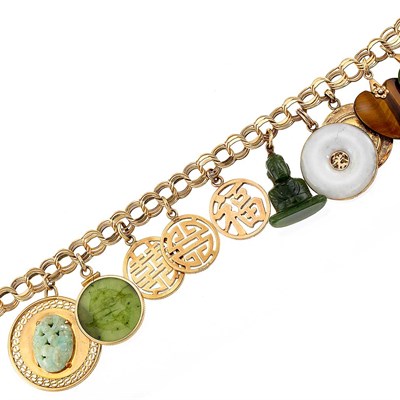 Lot 1319 - Gold, Jade and Tiger's Eye Charm Bracelet
