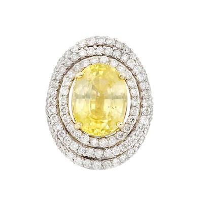 Lot 323 - Two-Color Gold, Yellow Sapphire and Diamond Ring