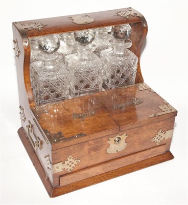 Lot 299 - Victorian Oak Tantalus With three cut glass...