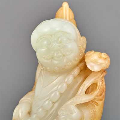 Lot 148 - Chinese White and Russet Jade Figure of a...