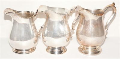 Lot 293 - Three American Sterling Silver Water Pitchers...