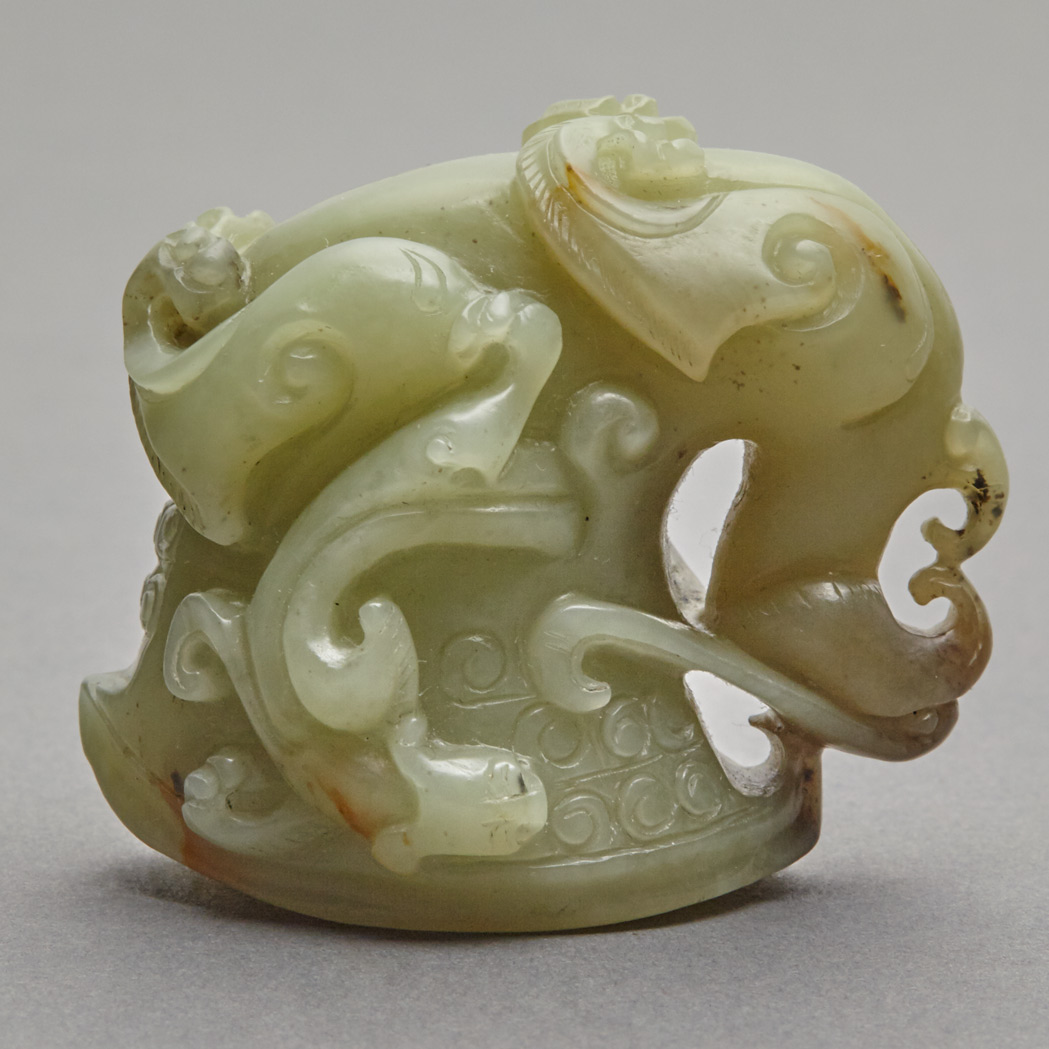 Lot 150 - Chinese Celadon and Russet Jade Rhyton Cup The...