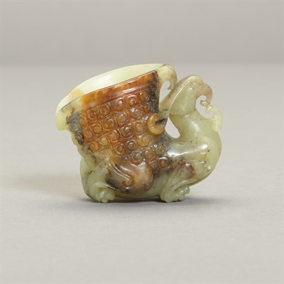 Lot 150 - Chinese Celadon and Russet Jade Rhyton Cup The...