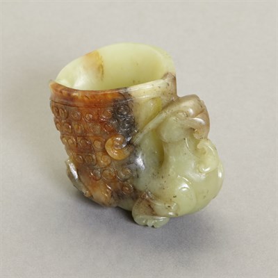 Lot 150 - Chinese Celadon and Russet Jade Rhyton Cup The...