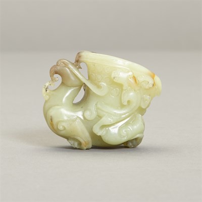 Lot 150 - Chinese Celadon and Russet Jade Rhyton Cup The...