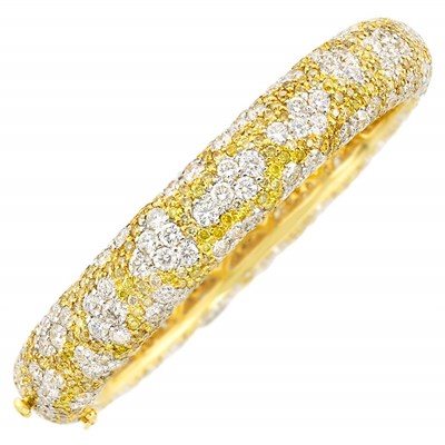 Lot 455 - Two-Color Gold, Diamond and Yellow Diamond Bangle Bracelet