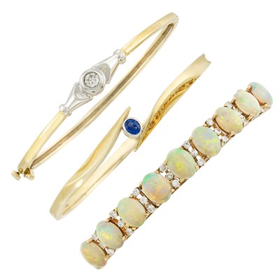 Lot 142 - Three Two-Color Gold, Diamond, Opal and Sapphire Bangle Bracelets