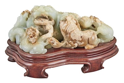 Lot 143 - Chinese Celadon and Russet Jade Buddhist Lion...