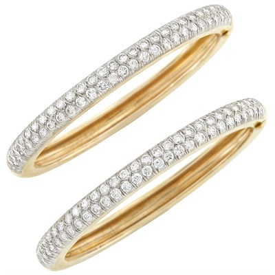 Lot 216 - Pair of Two-Color Gold and Diamond Bangle Bracelets