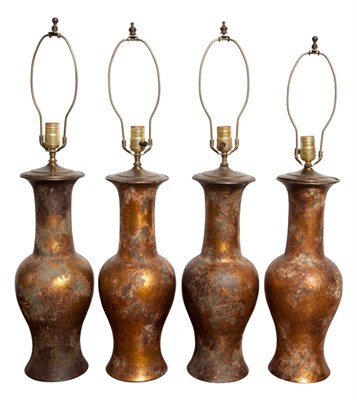 Lot 556 - Set of Four Patinated-Metal Lamps Height 18...