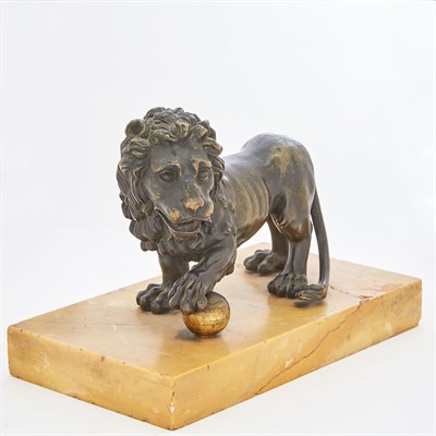 Lot 321 - Patinated-Bronze Sculpture of a Lion One paw...