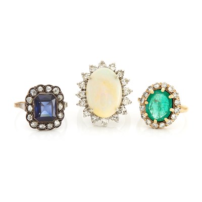 Lot 1487 - Three Yellow and White Gold, Silver, Opal, Emerald and Synthetic Stone Rings
