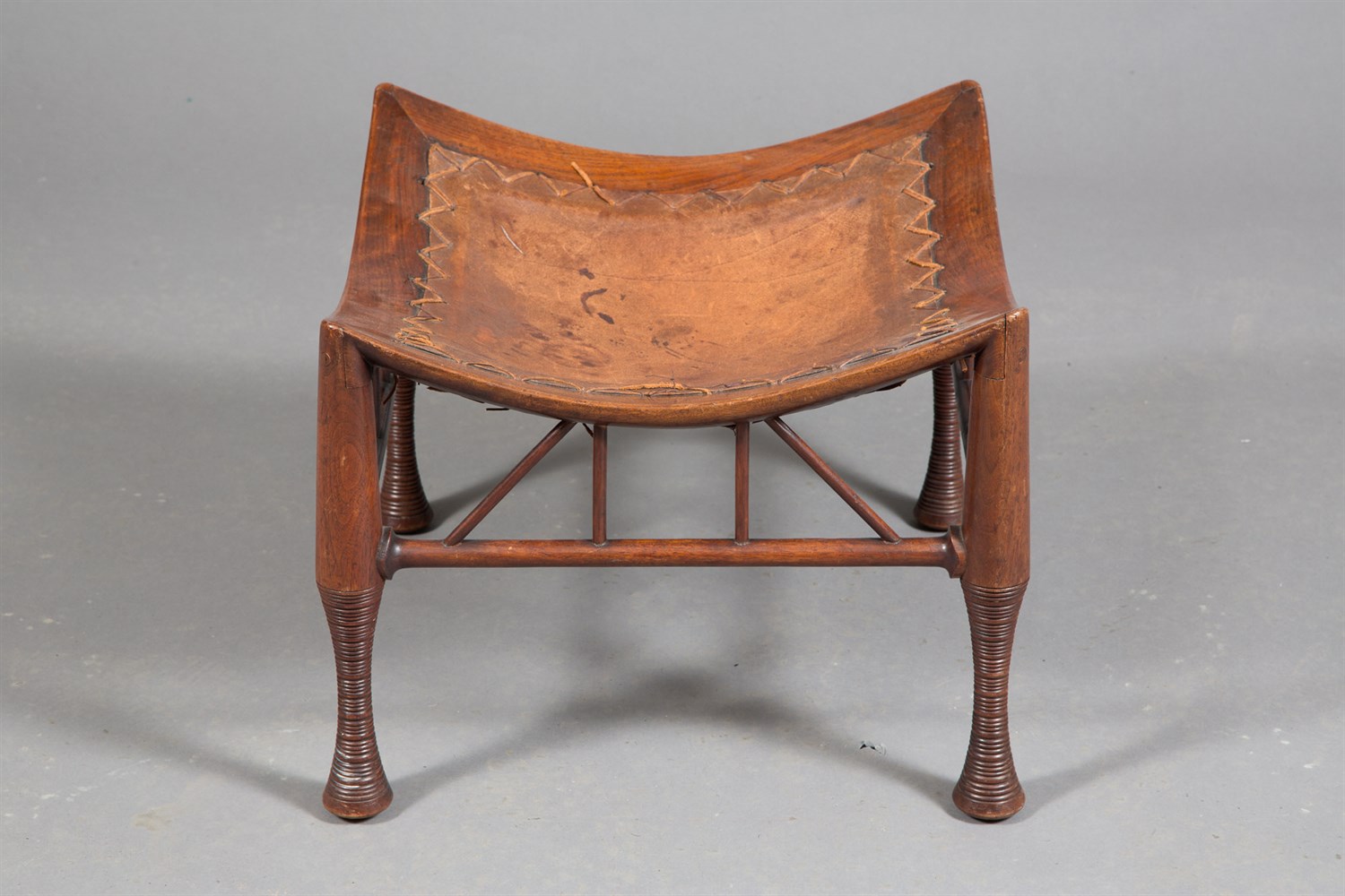 Lot 283 - Mahogany 'Thebes' Stool Possibly by Liberty &...