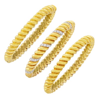 Lot 566 - Three Fluted Gold and Diamond Bangle Bracelets