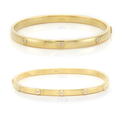 Lot 1140 - Two Two-Color Gold Bangle Bracelets