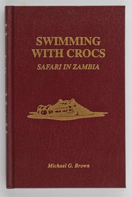 Lot 66 - BROWN, MICHAEL G. Swimming with Crocs. Safari...