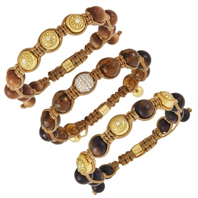 Lot 278 - Three Cord, Wood, Smoky Quartz and Gold Bead, Diamond and Brown Diamond Bracelets, by Shambala