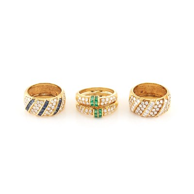 Lot 1965 - Three Gold, Diamond, Emerald and Sapphire Rings, Damiani