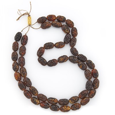 Lot 1028 - Double Strand Carved Amber and Gold Bead Necklace on String, by Linda Lee Johnson