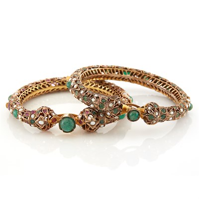Lot 1557 - Pair of Indian Low Karat Gold, Gem-Set and Split Pearl Bangle Bracelets