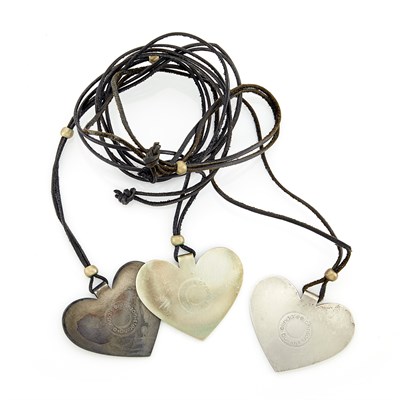 Lot 1088 - Three Silver 'Folded Heart' Pendants on Cord Necklaces, Linda Lee Johnson
