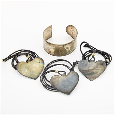 Lot 1090 - Three Silver 'Folded Heart' Pendants on Cord Necklaces and Cuff Bracelet, Linda Lee Johnson