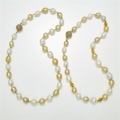 Lot 1234 - Pair of Semi-Baroque Golden and White Freshwater Pearl Necklaces with Two-Color Gold and Diamond Ball Clasps