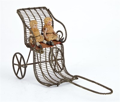 Lot 121 - Two Girls in Rickshaw Pull Toy Painted tin and...