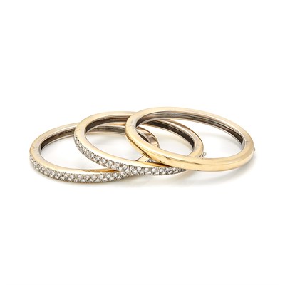 Lot 1311 - Three Gold-Plated Steel and Diamond Bangle Bracelet