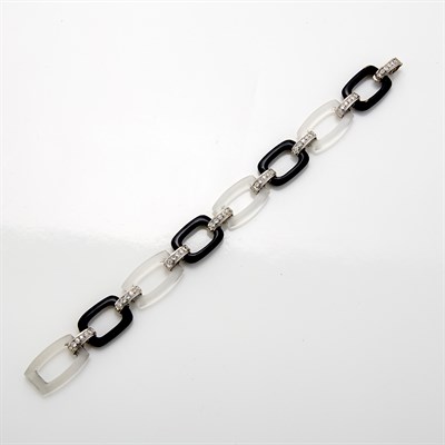 Lot 1076 - White Gold, Rock Crystal, Black Onyx and Diamond Bracelet