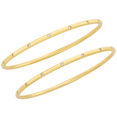 Lot 711 - Pair of Gold 'Etoile' Bangle Bracelets, Tiffany & Co.