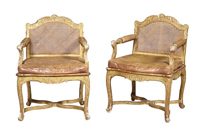 Lot 1165 - Pair of Régence Giltwood and Caned Fauteuils à...