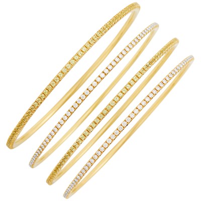Lot 120 - Tiffany & Co. Four Gold, Diamond and Yellow Sapphire Bangle Bracelets