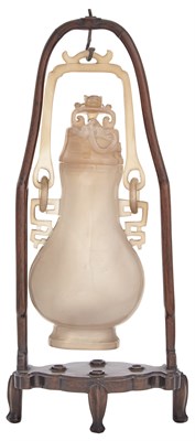 Lot 77 - A Chinese Carved Chalcedony Hanging Vase and...