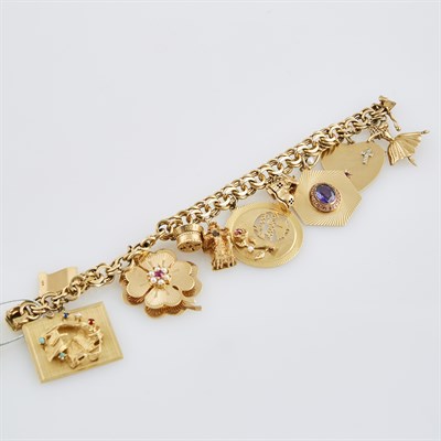 Lot 588 - Gold Charm Bracelet with 11 gold, bead and...