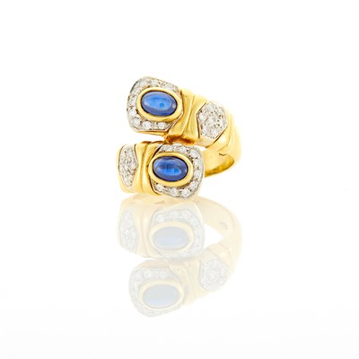 Lot 127 - Gold, Cabochon Sapphire and Diamond Crossover Ring
