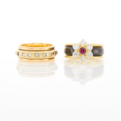Lot 1022 - Two-Color Gold, Diamond and Colored Diamond 'Spinning' Band Ring and Gold, Garnet, Diamond and Black Onyx Floret Ring