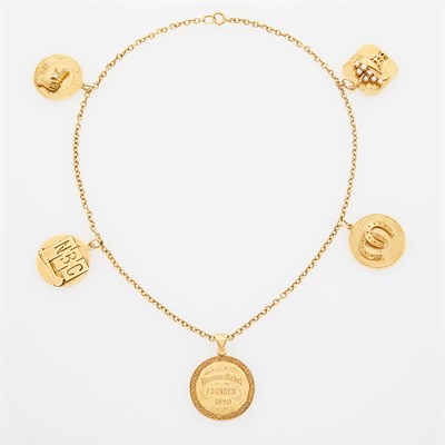 Lot 58 - CELESTE HOLM Gold and Gold Charm Necklace. 14...