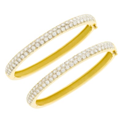 Lot 138 - Pair of Two-Color Gold and Diamond Bangle Bracelets