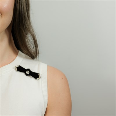 Lot 60 - Two-Color Gold, Black Onyx and Diamond Bow Brooch