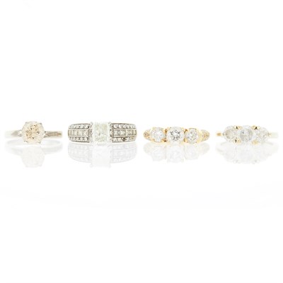 Lot 1256 - Four Yellow and White Gold, Silver, Colored Diamond, Diamond and Treated Diamond Rings