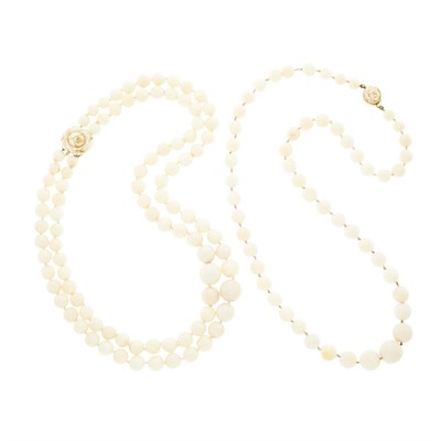 Lot 1252 - Two White Coral Bead Necklaces with Gold and Carved Coral Clasps