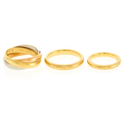 Lot 1010 - Tricolor Gold Rolling Band Ring and Two Gold Band Rings