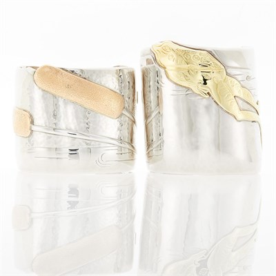 Lot 2098 - Tiffany & Co. Two Sterling Silver and Two-Color Gold Cuff Bracelets