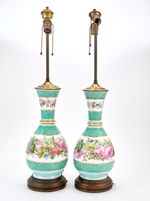 Lot 186 - Pair of Rose Decorated Bottle Form Porcelain Lamps