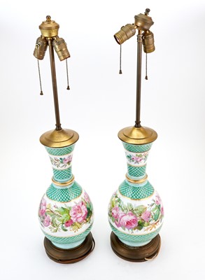 Lot 186 - Pair of Rose Decorated Bottle Form Porcelain Lamps